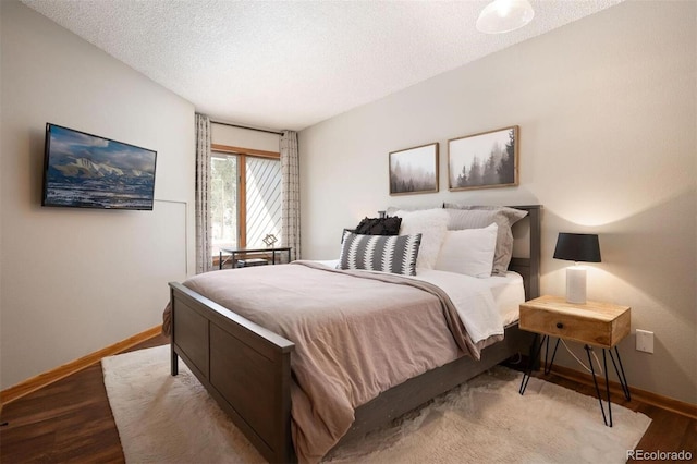 bedroom featuring light hardwood / wood-style floors and a textured ceiling