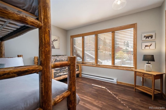 bedroom with dark wood-type flooring and a baseboard heating unit