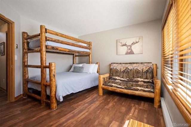 bedroom featuring a baseboard radiator and dark hardwood / wood-style floors