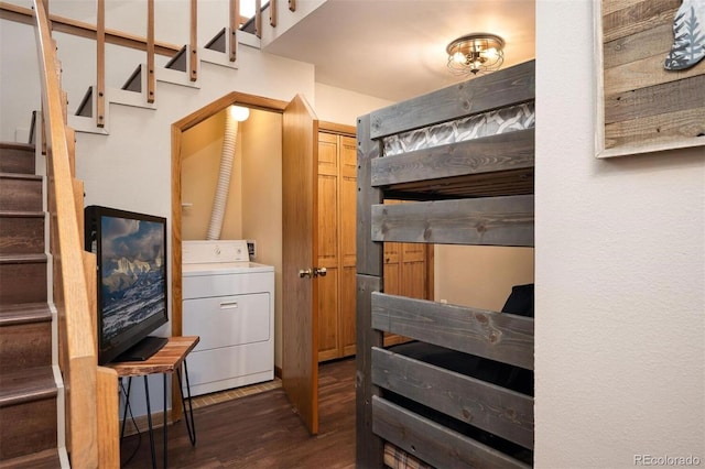 bedroom featuring a closet, washer / dryer, and dark hardwood / wood-style floors