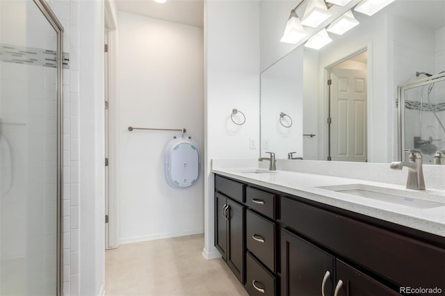 bathroom with a shower with shower door and vanity