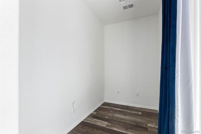 spare room with dark hardwood / wood-style floors