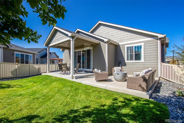 back of property with a yard and a patio area