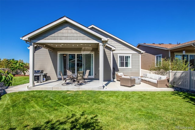 back of property with an outdoor hangout area, a yard, and a patio area