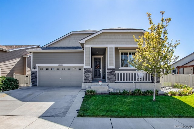 craftsman house featuring a garage, a front lawn, and a porch