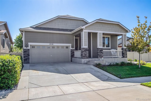 craftsman inspired home featuring a garage, a porch, and a front yard