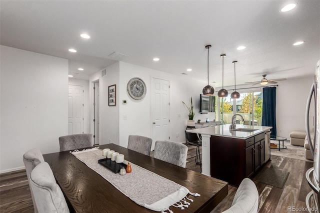 dining room with ceiling fan, dark hardwood / wood-style floors, and sink