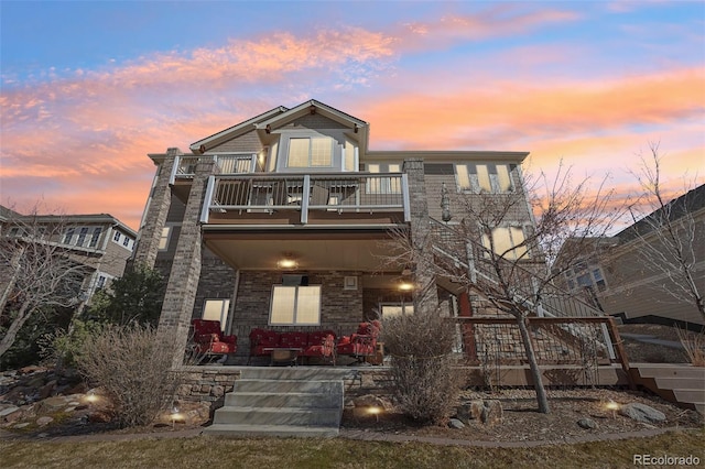 view of front facade featuring a balcony and covered porch