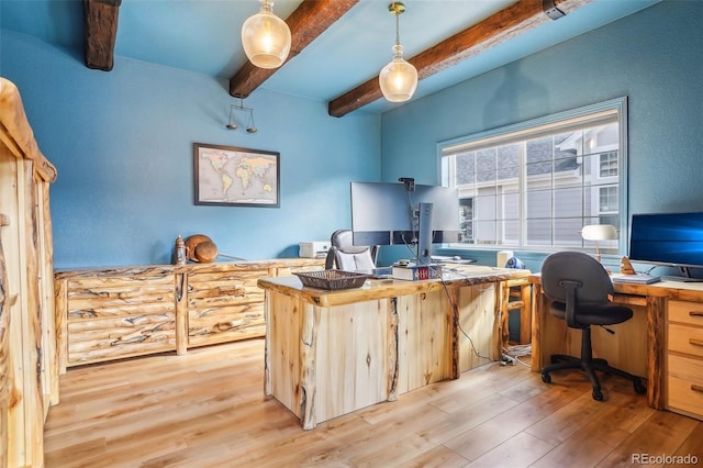 home office with light wood finished floors and beamed ceiling