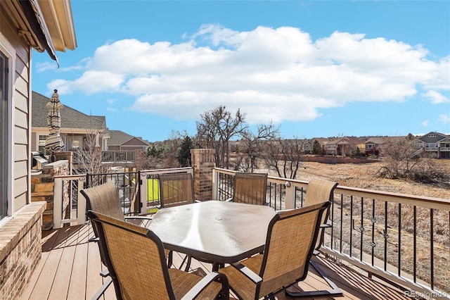 deck with a residential view and outdoor dining area