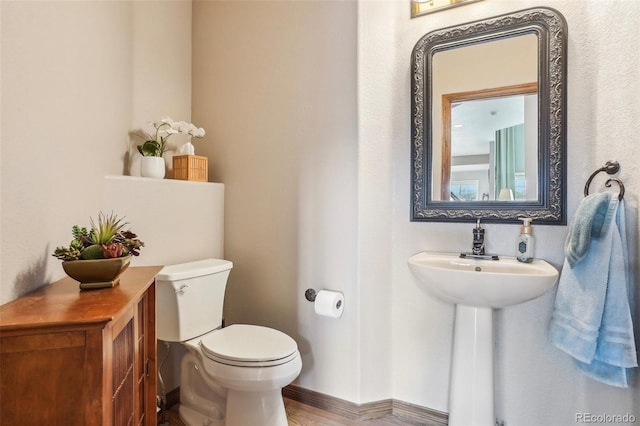 bathroom with toilet and a sink