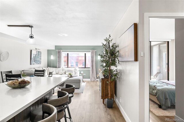 1551 Larimer St Unit 1405, Denver, CO 80202 - dining room with baseboards and light wood finished floors