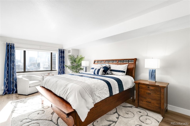 1551 Larimer St Unit 1405, Denver, CO 80202 - bedroom with baseboards and wood finished floors