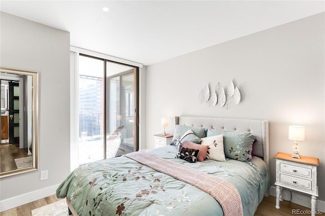 1551 Larimer St Unit 1405, Denver, CO 80202 - bedroom with baseboards, access to exterior, floor to ceiling windows, and light wood finished floors