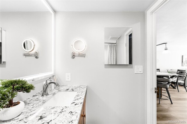 1551 Larimer St Unit 1405, Denver, CO 80202 - full bathroom featuring vanity and wood finished floors