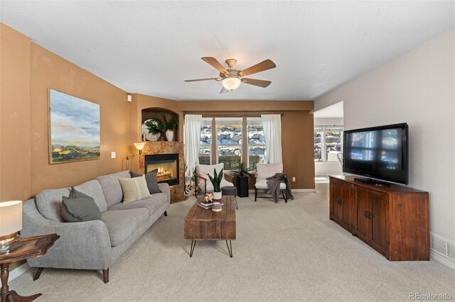 living room featuring ceiling fan and light colored carpet