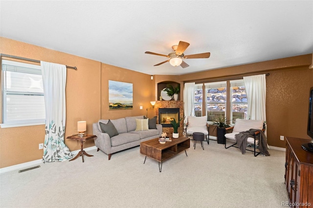 carpeted living room featuring ceiling fan