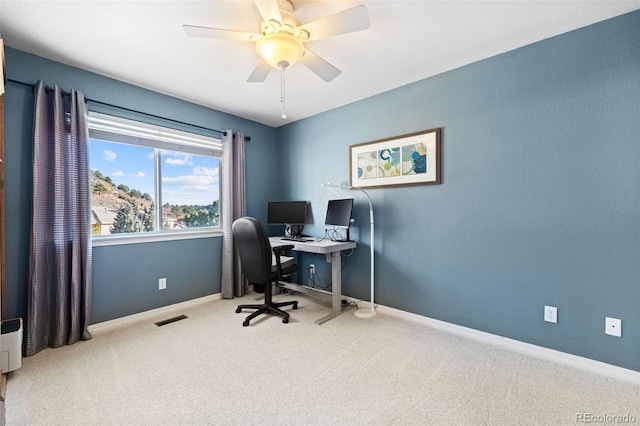 carpeted home office with ceiling fan