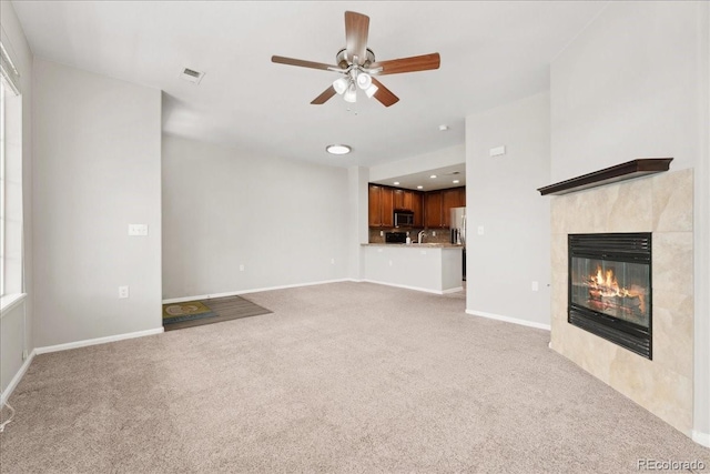 16212 E Geddes Ln Unit 11, Aurora, CO 80016 - unfurnished living room with light colored carpet, ceiling fan, a tile fireplace, baseboards, and recessed lighting