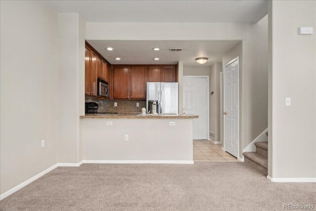 16212 E Geddes Ln Unit 11, Aurora, CO 80016 - kitchen with appliances with stainless steel finishes, light colored carpet, baseboards, backsplash, and recessed lighting