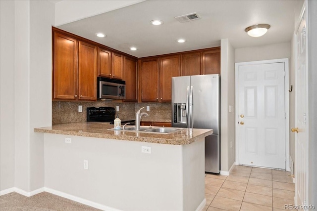 16212 E Geddes Ln Unit 11, Aurora, CO 80016 - kitchen featuring appliances with stainless steel finishes, a peninsula, a sink, backsplash, and baseboards