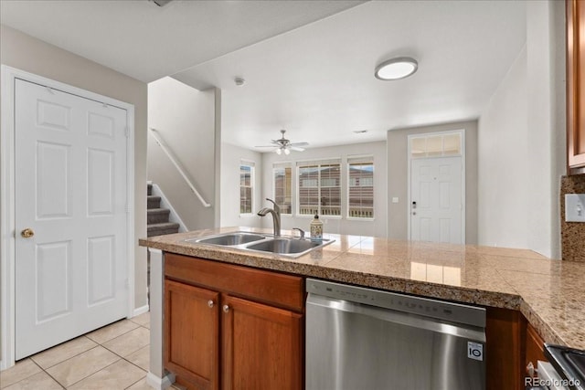 16212 E Geddes Ln Unit 11, Aurora, CO 80016 - kitchen with stainless steel dishwasher, tile counters, a sink, and brown cabinets