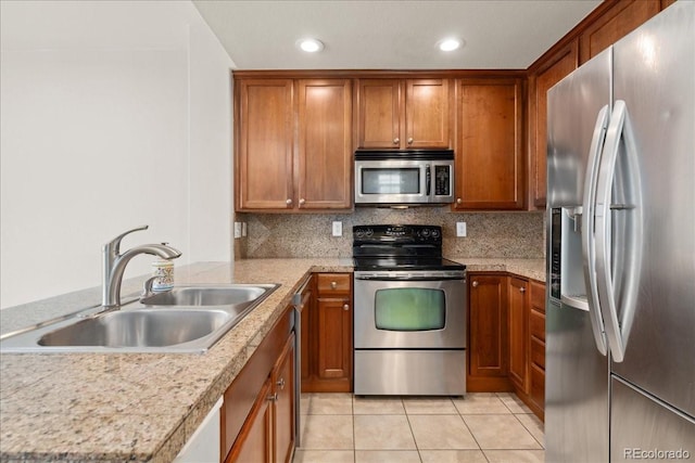 16212 E Geddes Ln Unit 11, Aurora, CO 80016 - kitchen featuring stainless steel appliances, a sink, brown cabinetry, light tile patterned flooring, and light countertops