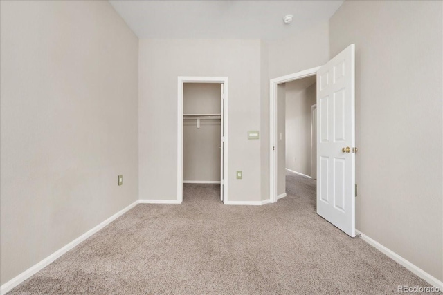 16212 E Geddes Ln Unit 11, Aurora, CO 80016 - unfurnished bedroom with carpet floors, baseboards, and a walk in closet