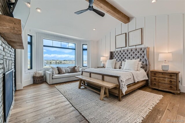 bedroom featuring ceiling fan, lofted ceiling with beams, and light hardwood / wood-style floors