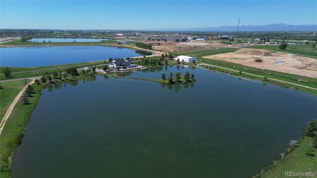 birds eye view of property with a water and mountain view