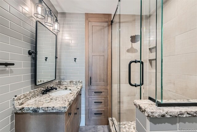 bathroom featuring an enclosed shower and vanity