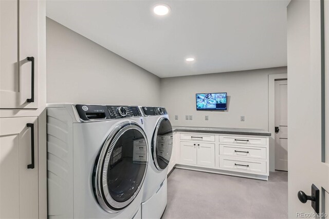 laundry area with washer and clothes dryer and cabinets