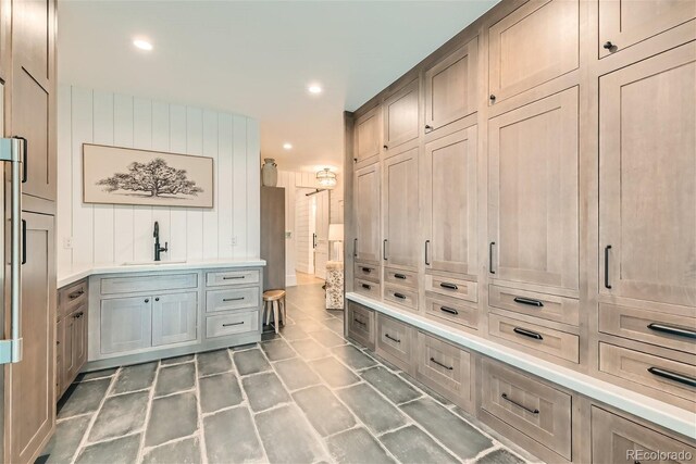 mudroom with sink and wooden walls