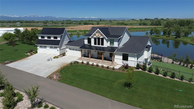 birds eye view of property with a water and mountain view