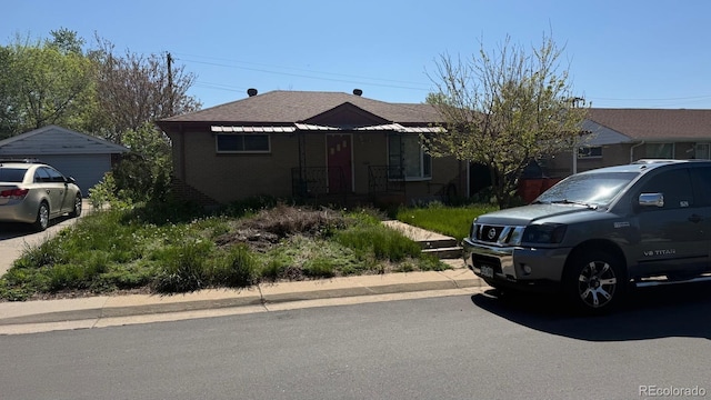 7488 Quivas St, Denver, CO 80221 - view of front of property featuring a garage and brick siding