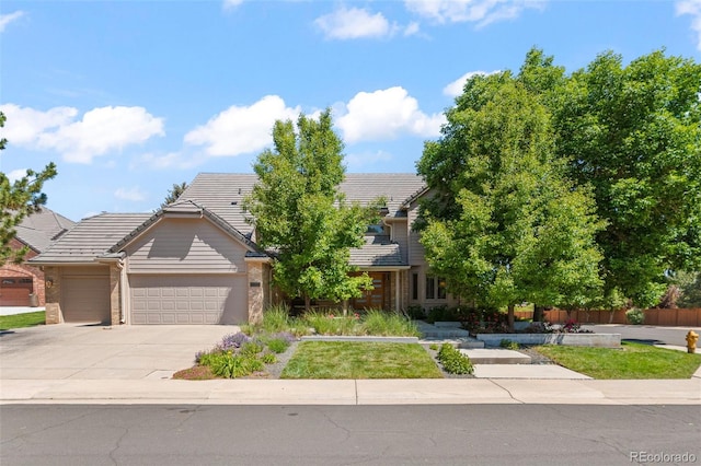 10293 E Sheri Ln, Englewood, CO 80111 - obstructed view of property with a garage, a tiled roof, driveway, and brick siding