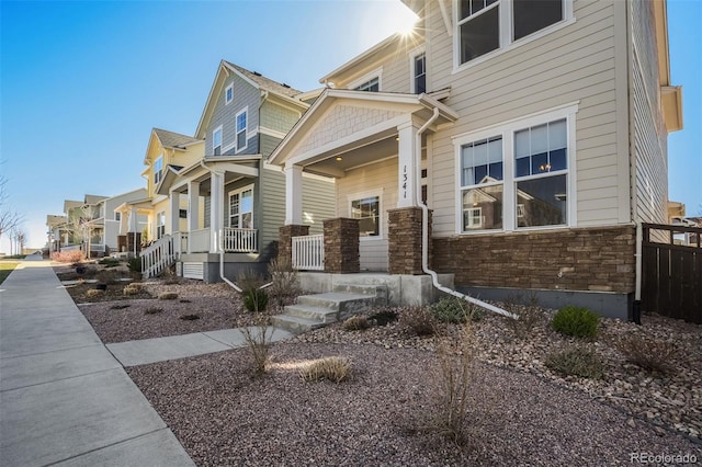 1341 Solitaire St, Colorado Springs, CO 80905 - view of property exterior featuring stone siding and covered porch