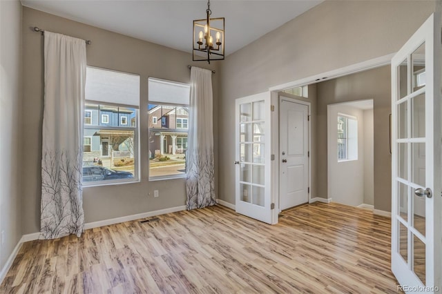 1341 Solitaire St, Colorado Springs, CO 80905 - interior space featuring a wealth of natural light, wood finished floors, french doors, and a notable chandelier