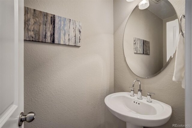1341 Solitaire St, Colorado Springs, CO 80905 - bathroom featuring a textured wall and a sink