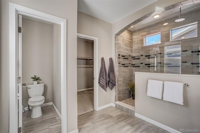 1341 Solitaire St, Colorado Springs, CO 80905 - full bath featuring toilet, a walk in closet, baseboards, and walk in shower