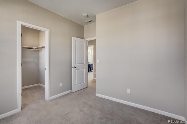 1341 Solitaire St, Colorado Springs, CO 80905 - unfurnished bedroom featuring a closet, carpet flooring, a walk in closet, baseboards, and visible vents