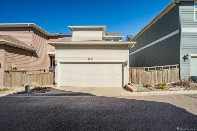 1341 Solitaire St, Colorado Springs, CO 80905 - view of front facade with fence and a garage