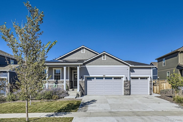 craftsman house featuring covered porch and a garage