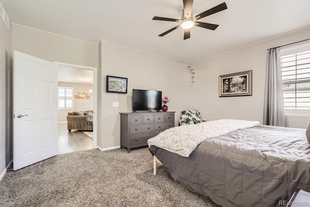 carpeted bedroom with multiple windows and ceiling fan