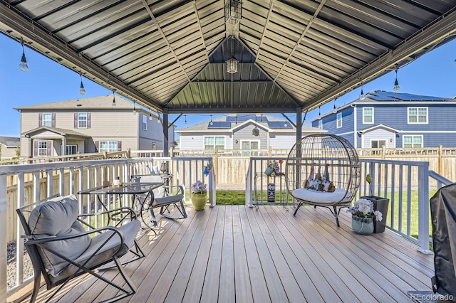 wooden terrace featuring a gazebo