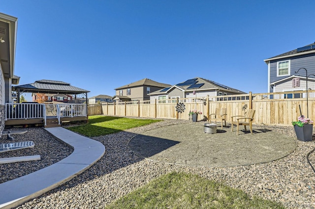 view of yard featuring a gazebo, a deck, and a patio