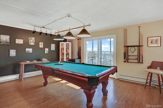 game room with rail lighting, billiards, wood finished floors, and a baseboard radiator