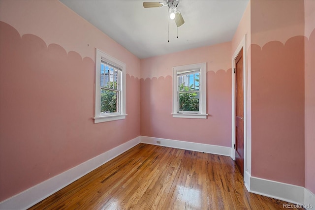 unfurnished room with light wood-type flooring and ceiling fan