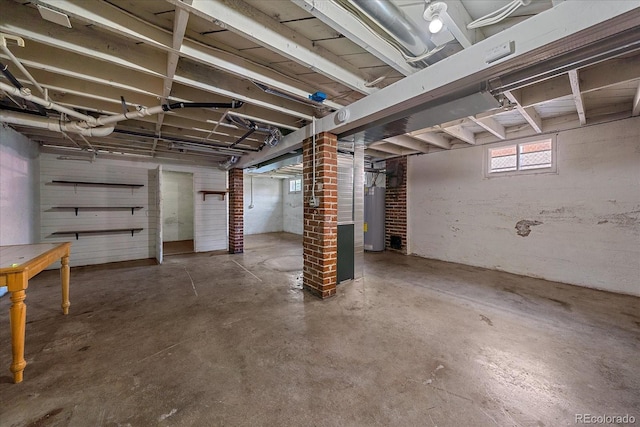 basement with water heater and brick wall