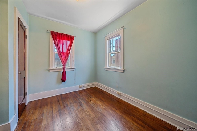 unfurnished room with hardwood / wood-style floors